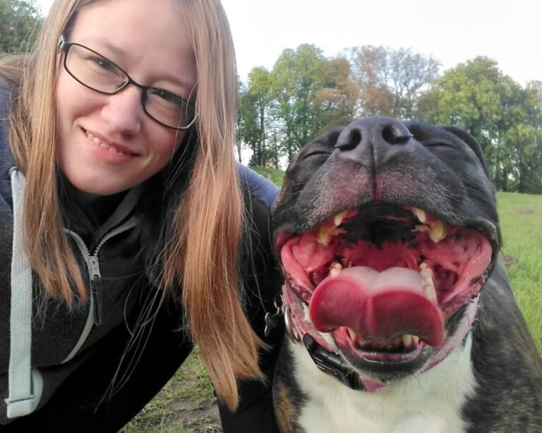 Smiling woman with even smilier staffordshire bull terrier